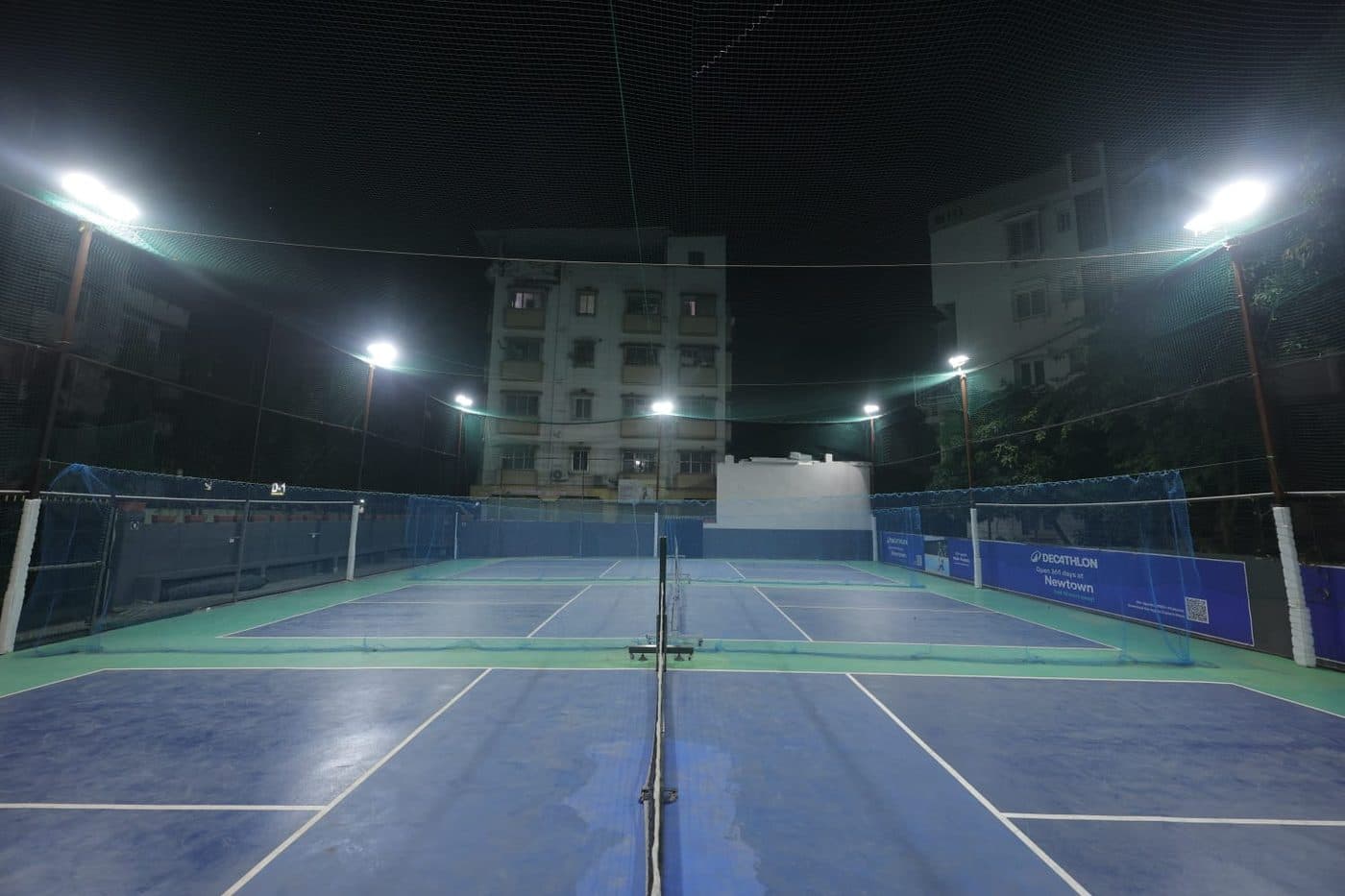 Breathe Pickleball courts lit up at night