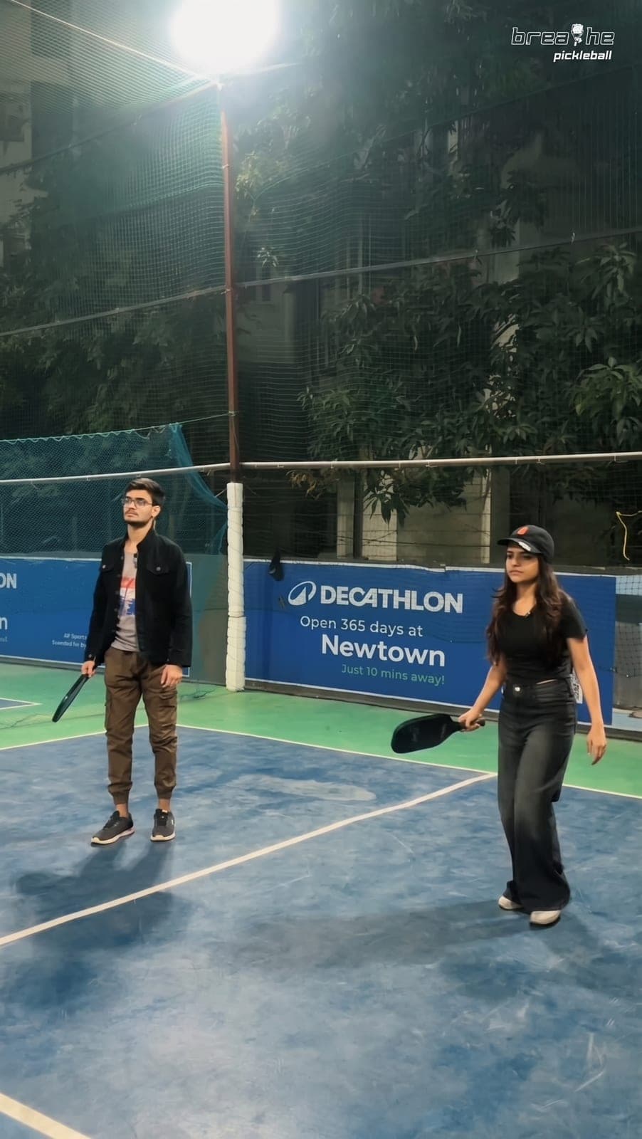 Two players mid-rally on the blue court
